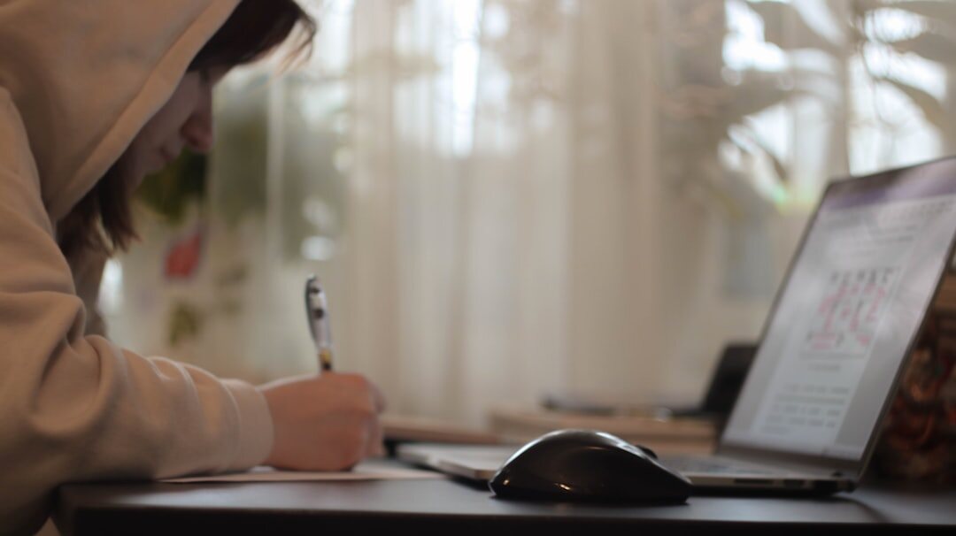 blogger writing on laptop